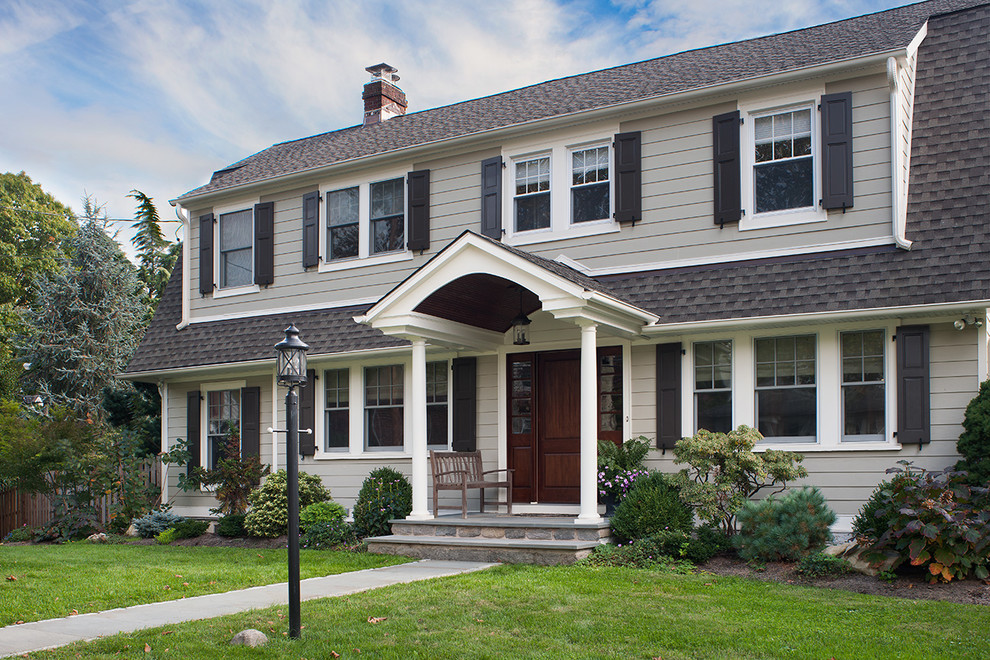 Inspiration for a mid-sized timeless beige two-story wood exterior home remodel in Philadelphia with a gambrel roof