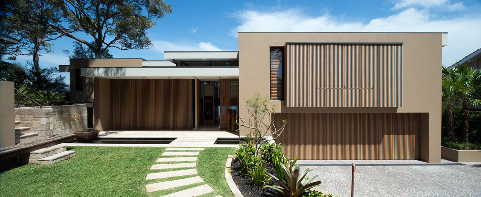 Large and brown contemporary bungalow house exterior in Sydney with a flat roof.
