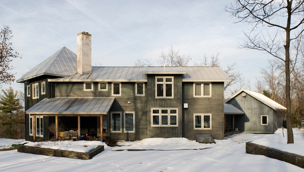 Inspiration for a large contemporary green two-story wood gable roof remodel in Boston