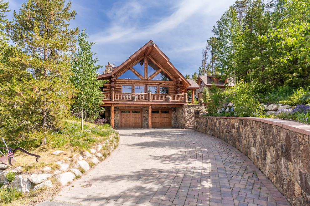 Example of a large mountain style brown two-story wood exterior home design in Denver with a shingle roof