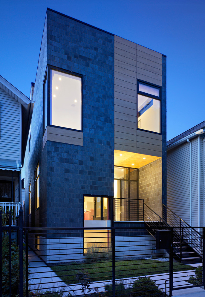 Inspiration for a medium sized and black modern brick house exterior in Chicago with three floors.
