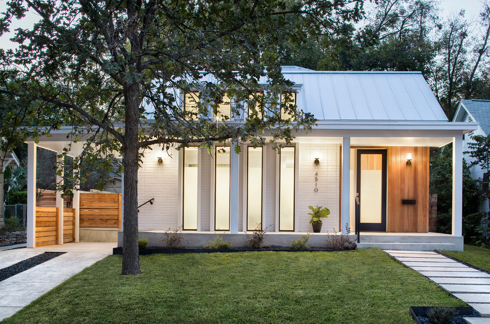 Inspiration pour une petite façade de maison blanche design de plain-pied avec un revêtement mixte, un toit à deux pans et un toit en métal.