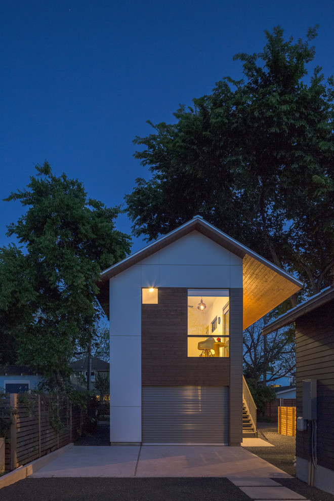 Example of a small transitional white two-story concrete fiberboard gable roof design in Austin