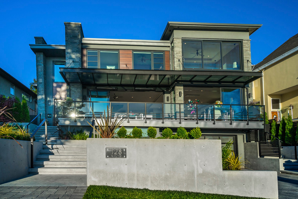Large and gey contemporary detached house in Vancouver with three floors, mixed cladding and a flat roof.
