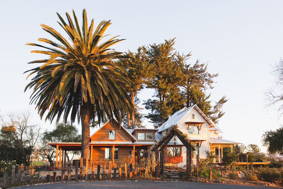 Inspiration for a medium sized rural two floor house exterior in San Francisco with wood cladding and a pitched roof.