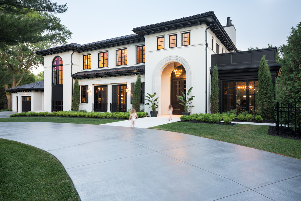 Inspiration for a mediterranean white two-story house exterior remodel in Minneapolis with a tile roof