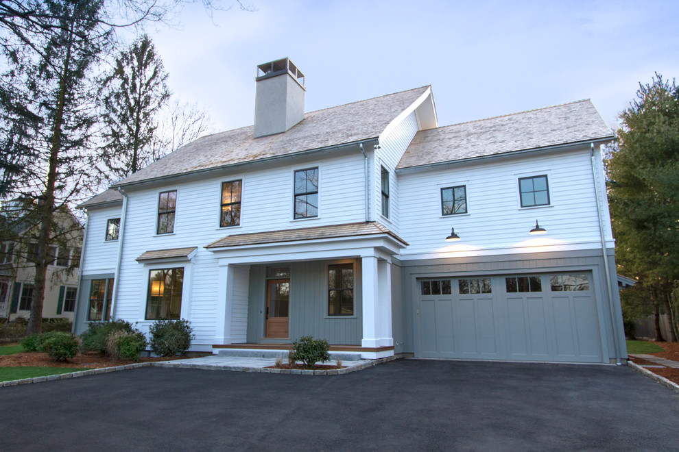 Inspiration for a large country white three-story wood gable roof remodel in New York