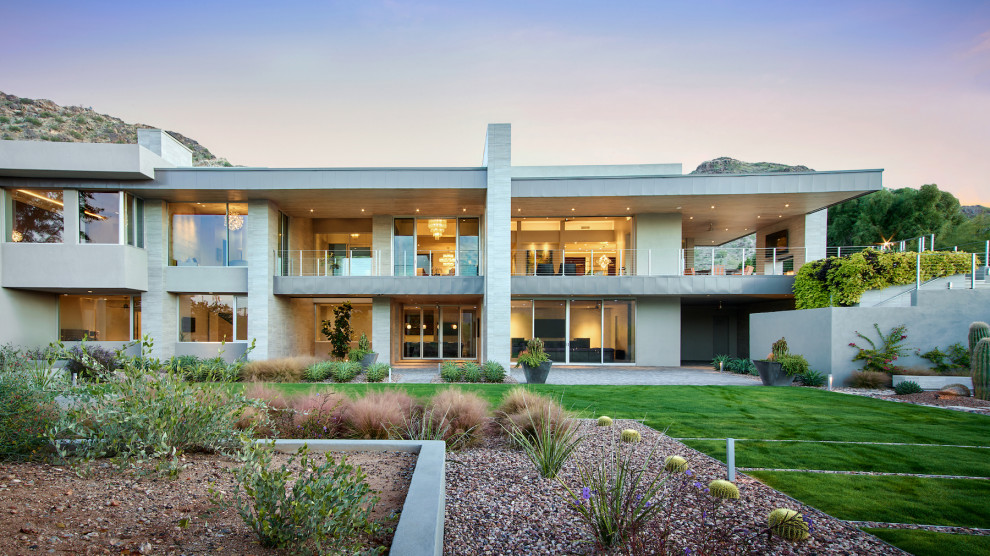 Ejemplo de fachada de casa beige moderna extra grande de dos plantas con revestimiento de piedra y tejado plano