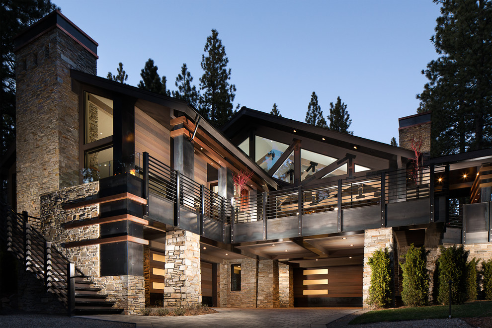 Inspiration for a huge modern brown two-story mixed siding house exterior remodel in Other with a shingle roof