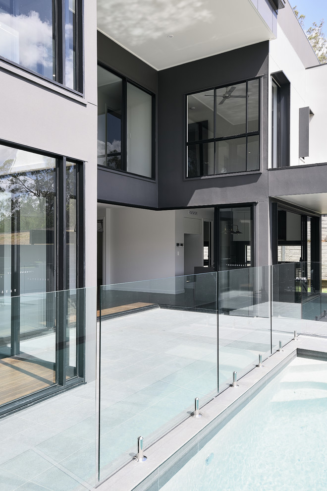 Großes, Zweistöckiges Modernes Einfamilienhaus mit Mix-Fassade, grauer Fassadenfarbe, Flachdach und Blechdach in Brisbane