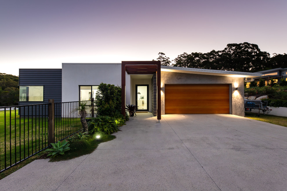 Industrial multicolored one-story mixed siding house exterior idea in Sunshine Coast with a shed roof and a metal roof