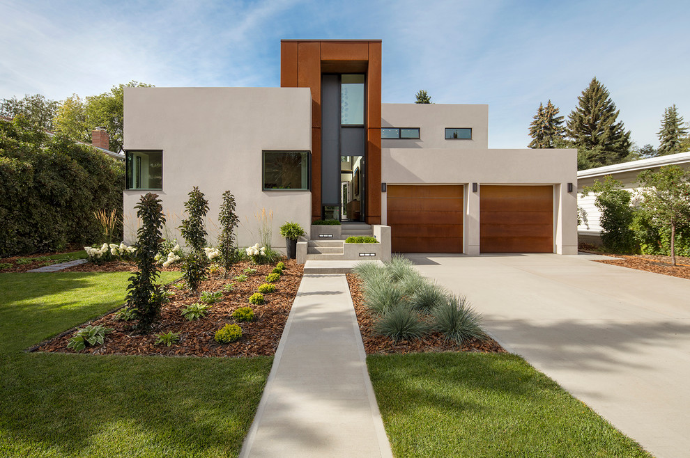 Beige contemporary house exterior in Edmonton with mixed cladding and a flat roof.