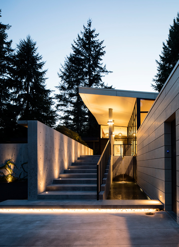 This is an example of a beige modern bungalow house exterior in Seattle with concrete fibreboard cladding and a hip roof.