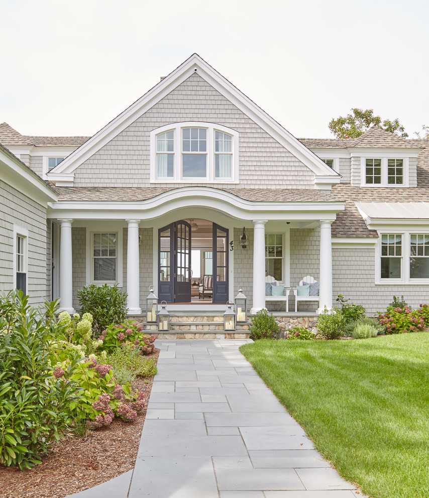 Example of a mid-sized classic gray two-story exterior home design in Boston with a shingle roof