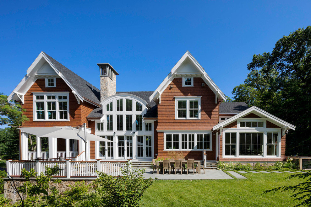 Large elegant brown two-story wood exterior home photo in Boston with a shingle roof