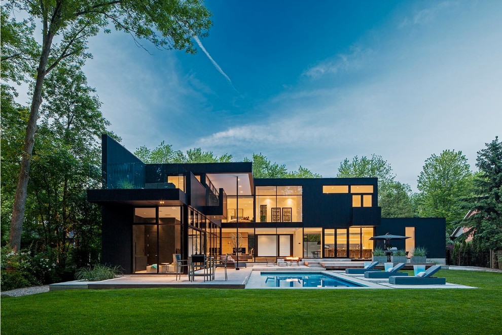 Großes, Zweistöckiges Modernes Haus mit schwarzer Fassadenfarbe und Flachdach in Sonstige