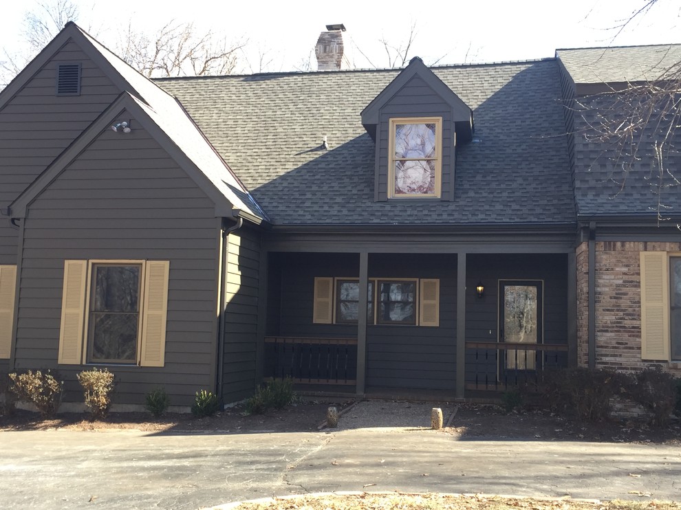 Large mountain style brown two-story vinyl exterior home photo in St Louis with a shingle roof