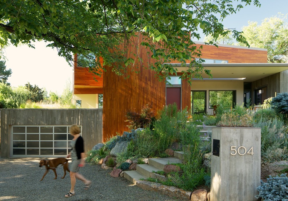 Inspiration for a contemporary two floor house exterior in Denver with wood cladding.