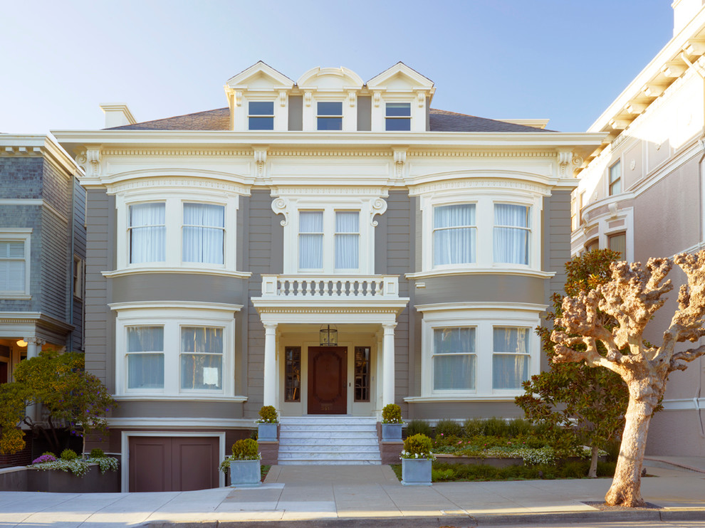 Inspiration for a large traditional house exterior in San Francisco with three floors, wood cladding and a hip roof.