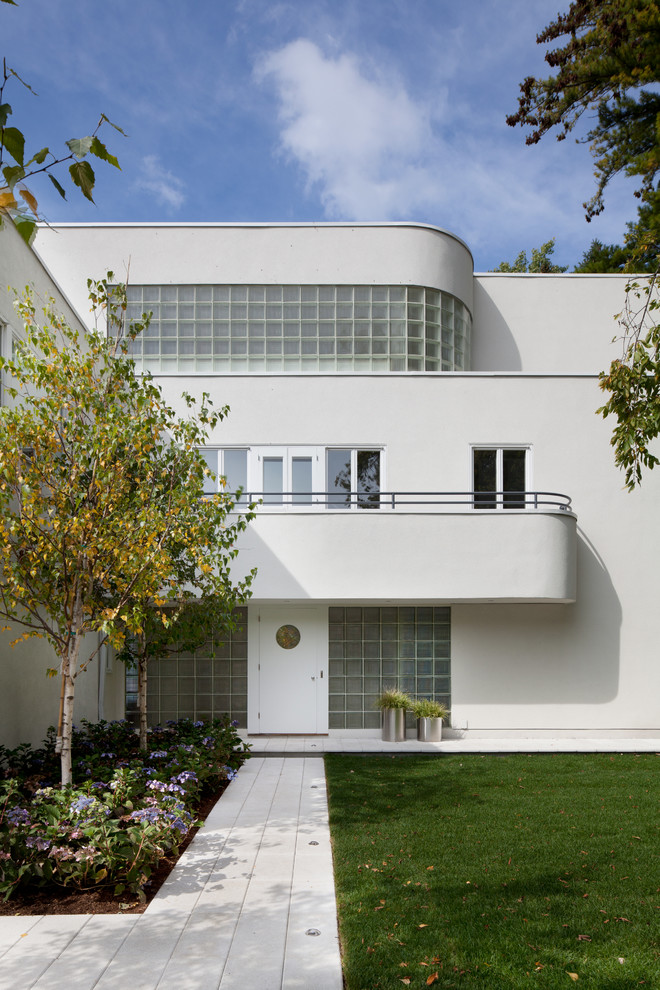 Inspiration for a white modern house exterior in Minneapolis with three floors.