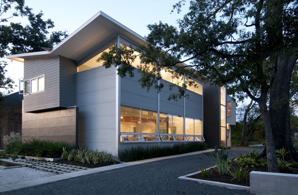 Modern house exterior in Houston with metal cladding and a butterfly roof.