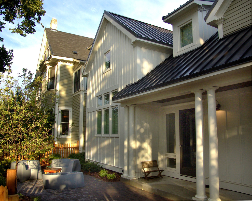 This is an example of a large and green traditional two floor house exterior in Minneapolis with concrete fibreboard cladding.