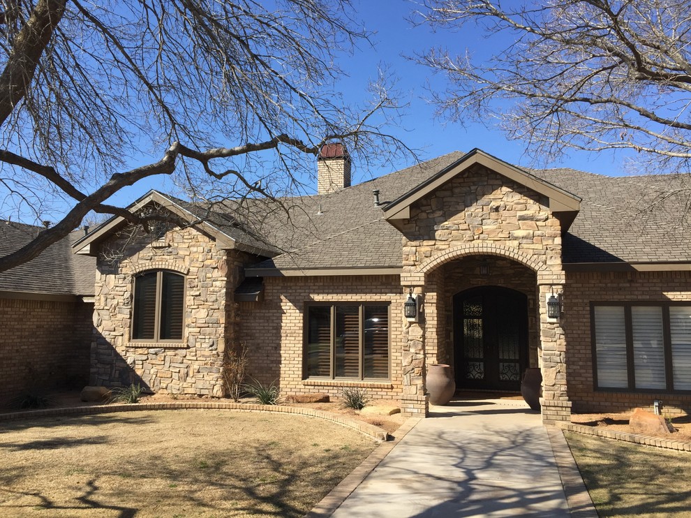 Photo of a large and beige rustic bungalow house exterior in Austin with stone cladding.
