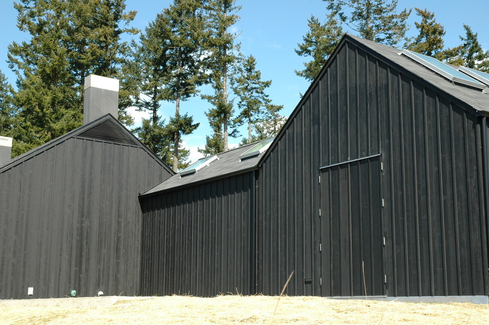 Example of a large minimalist black one-story exterior home design in Seattle
