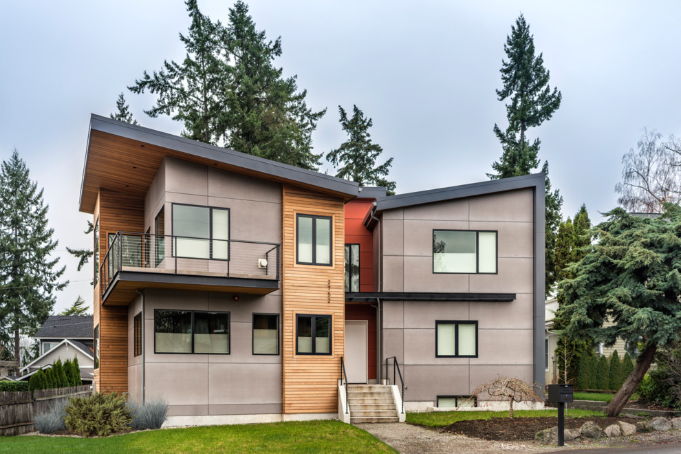 На фото: двухэтажный, серый, большой частный загородный дом в современном стиле с комбинированной облицовкой, односкатной крышей и металлической крышей с