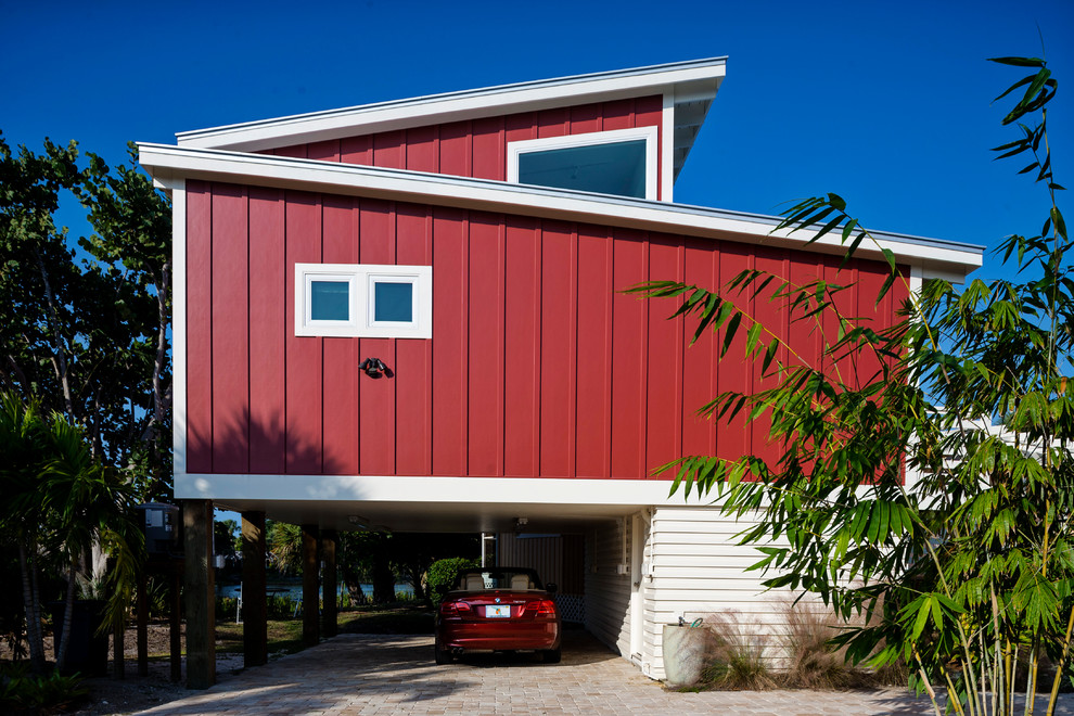 Design ideas for a small and red modern bungalow house exterior in Miami with wood cladding and a flat roof.