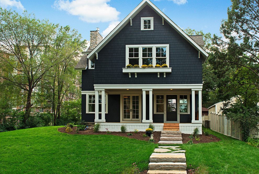 Inspiration for a traditional house exterior in Minneapolis with wood cladding and a pitched roof.