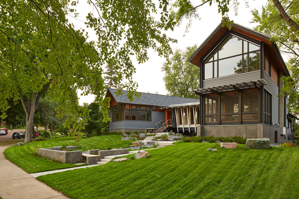 This is an example of a contemporary two floor house exterior in Minneapolis with a pitched roof.