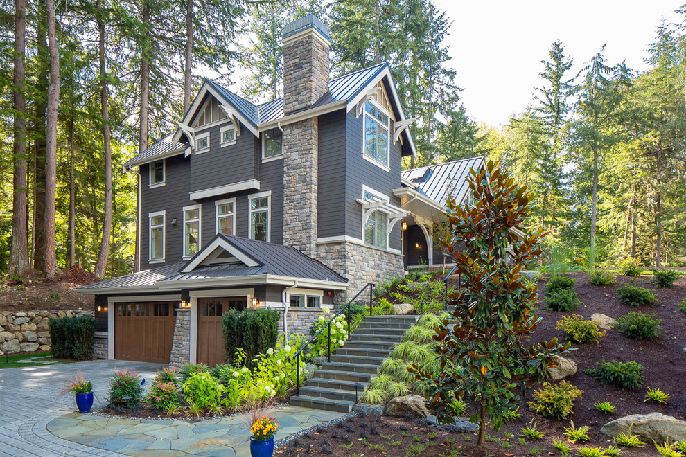 Example of a large classic gray two-story wood exterior home design in Seattle with a metal roof