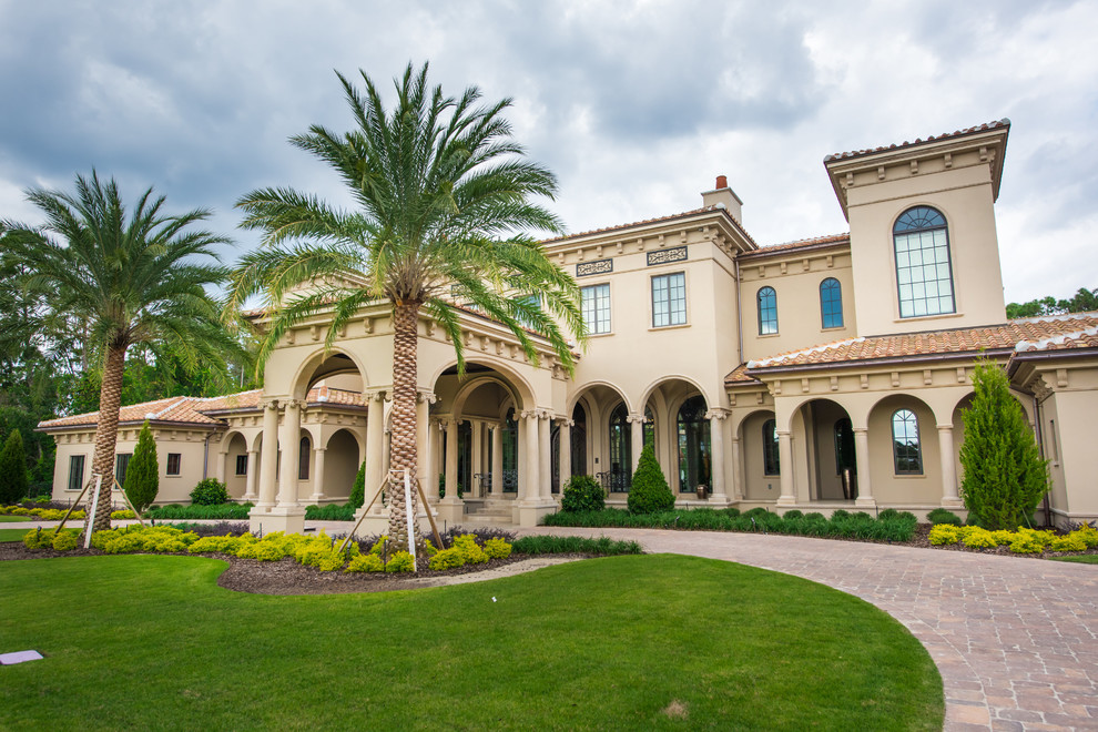 Design ideas for a beige mediterranean render house exterior in Orlando.