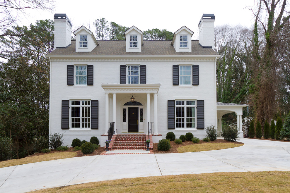 Example of a large classic white two-story brick exterior home design in Atlanta