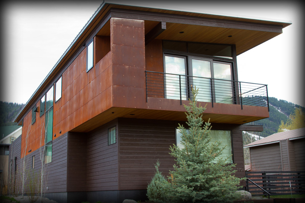 Mid-sized trendy multicolored two-story metal house exterior photo in Other with a shed roof and a metal roof