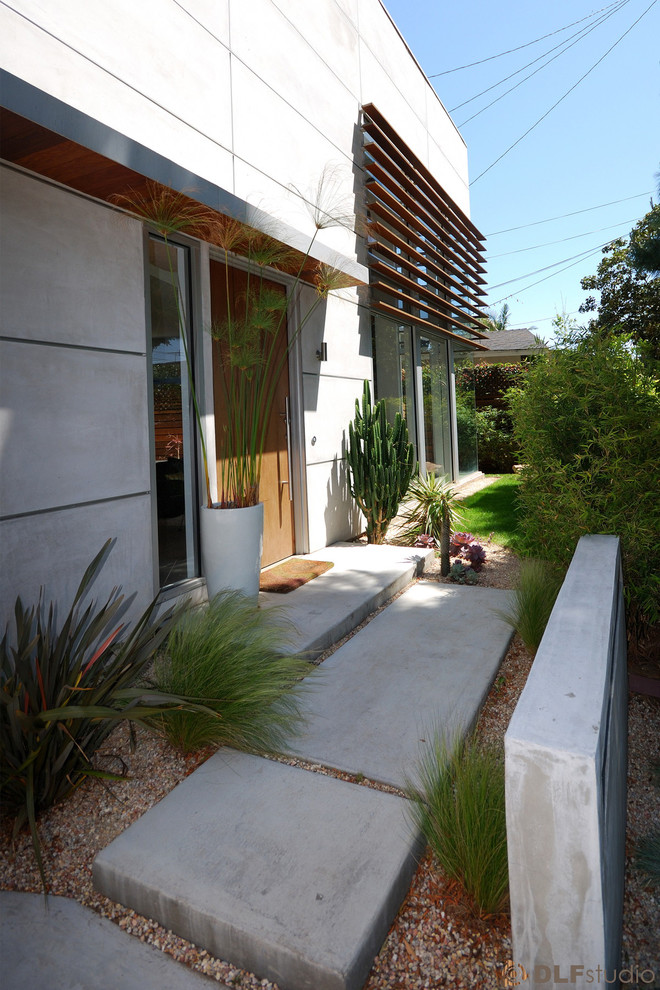 This is an example of a medium sized and gey modern two floor render house exterior in Los Angeles.