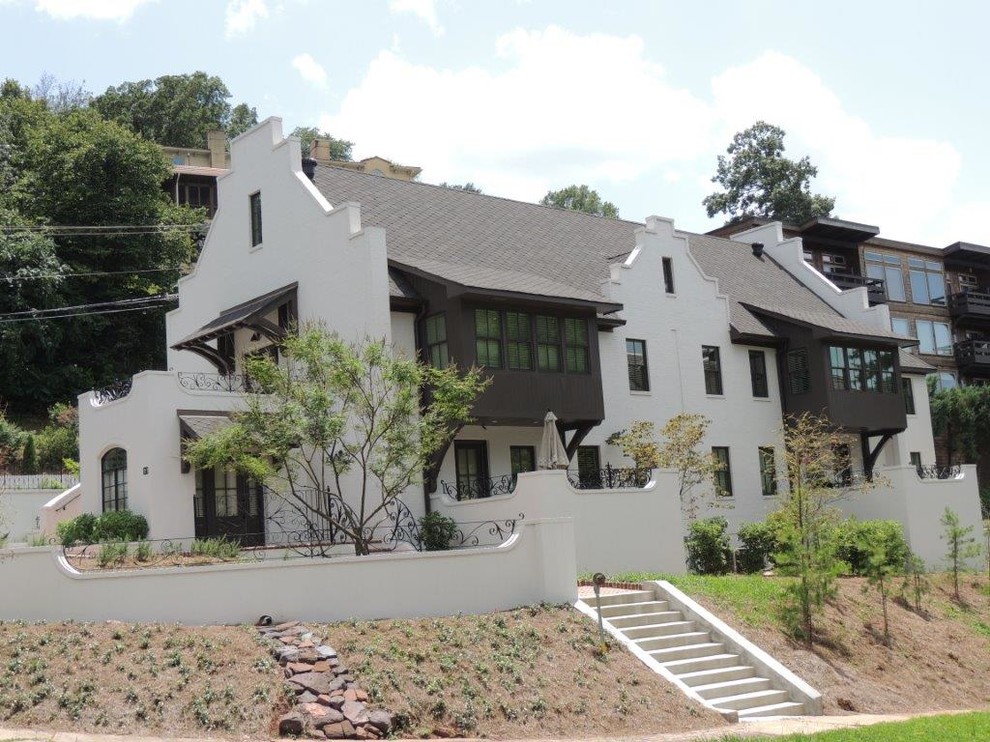 Example of a large southwest white two-story brick exterior home design in Birmingham with a shingle roof