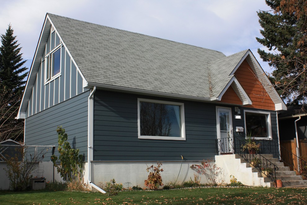 Design ideas for a small and blue traditional split-level detached house in Calgary with concrete fibreboard cladding, a pitched roof and a shingle roof.