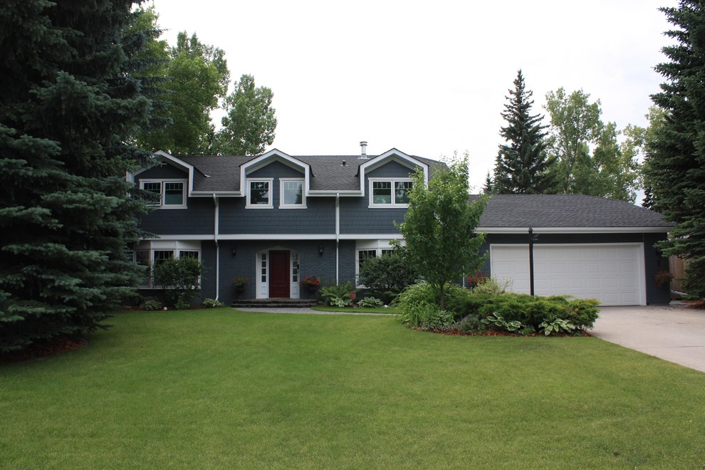 Large elegant blue two-story concrete fiberboard house exterior photo in Calgary with a clipped gable roof and a shingle roof