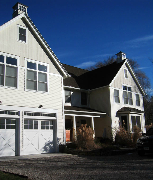 Immagine della facciata di una casa grande bianca classica a due piani con rivestimento in legno