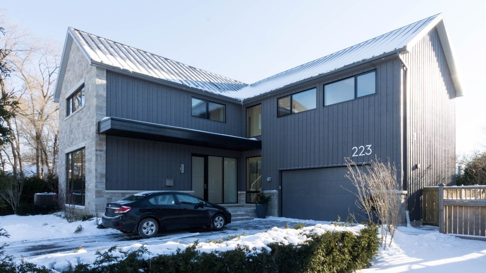 Large trendy gray two-story mixed siding gable roof photo in Toronto