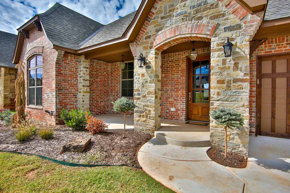 Mid-sized traditional red one-story brick gable roof idea in Oklahoma City