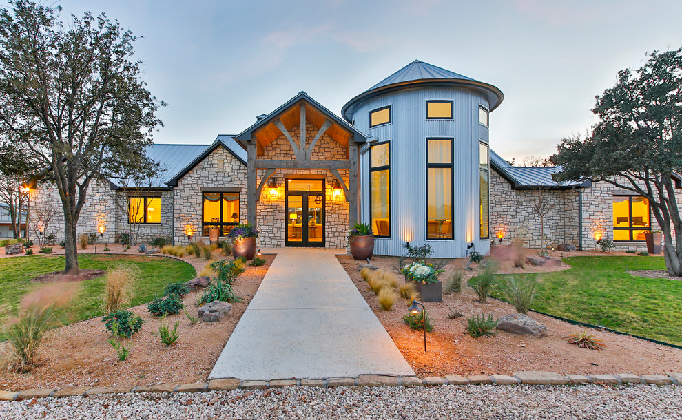 Large contemporary two floor house exterior in Dallas with stone cladding.