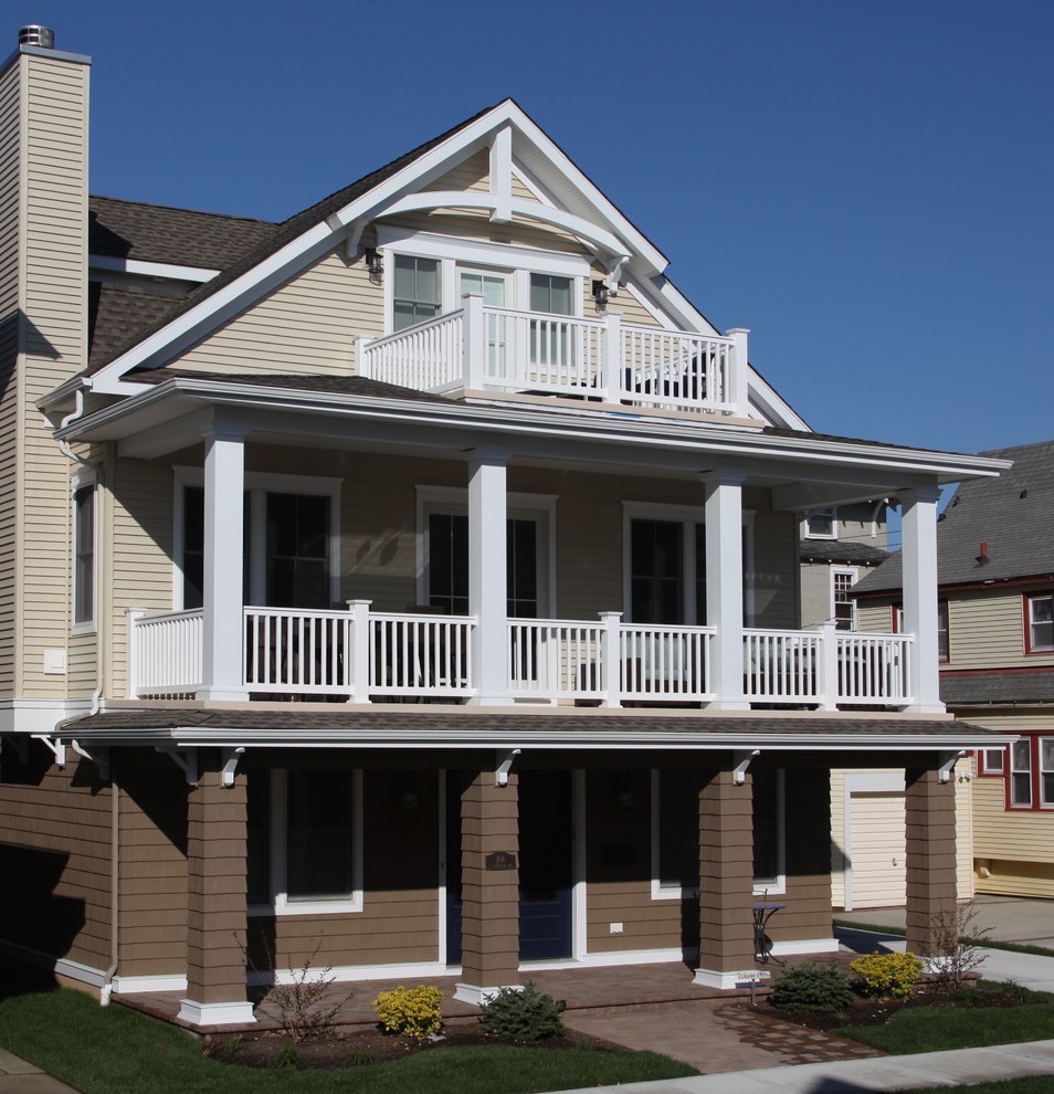 Example of a mid-sized island style three-story wood exterior home design in Philadelphia