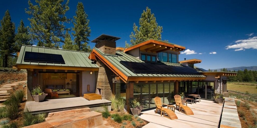 Cette image montre une façade de maison multicolore bohème de taille moyenne et de plain-pied avec un revêtement mixte, un toit à deux pans et un toit en métal.