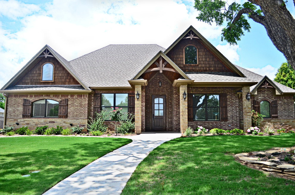 This is an example of a traditional two floor house exterior in Austin with mixed cladding.