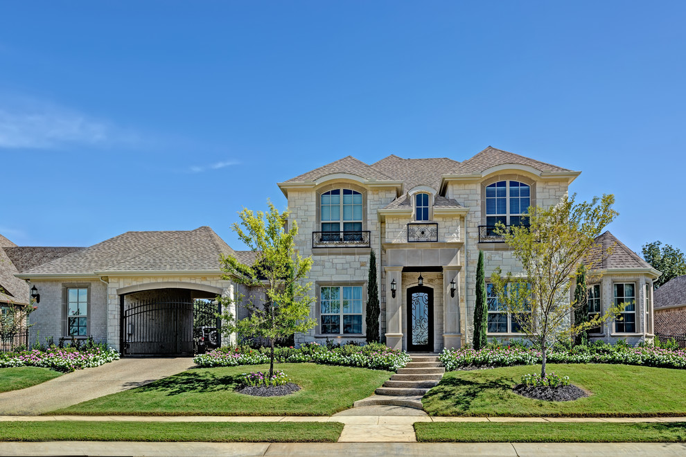 Large mediterranean beige two-story mixed siding house exterior idea in Dallas with a shingle roof