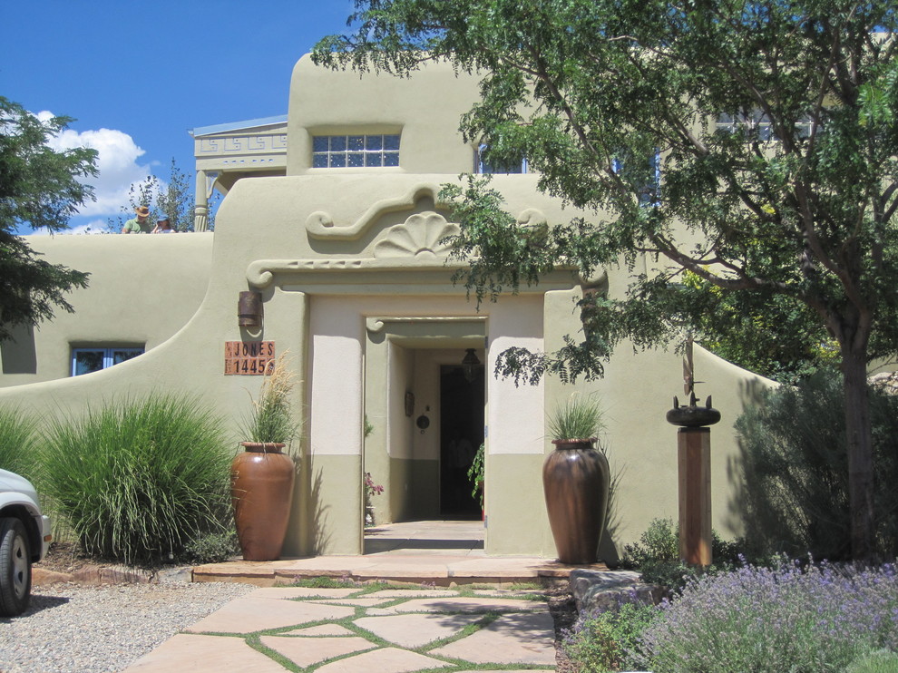 Design ideas for a beige mediterranean house exterior in Albuquerque.
