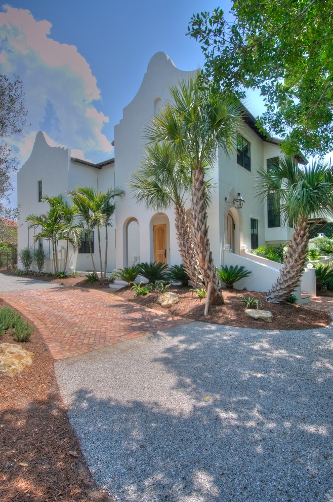 Inspiration for a large mediterranean white two-story stucco gable roof remodel in Tampa